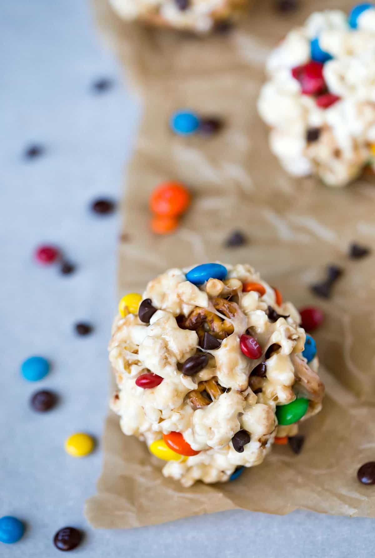 Sweet & Salty Popcorn Balls next to M&Ms and chocolate chips