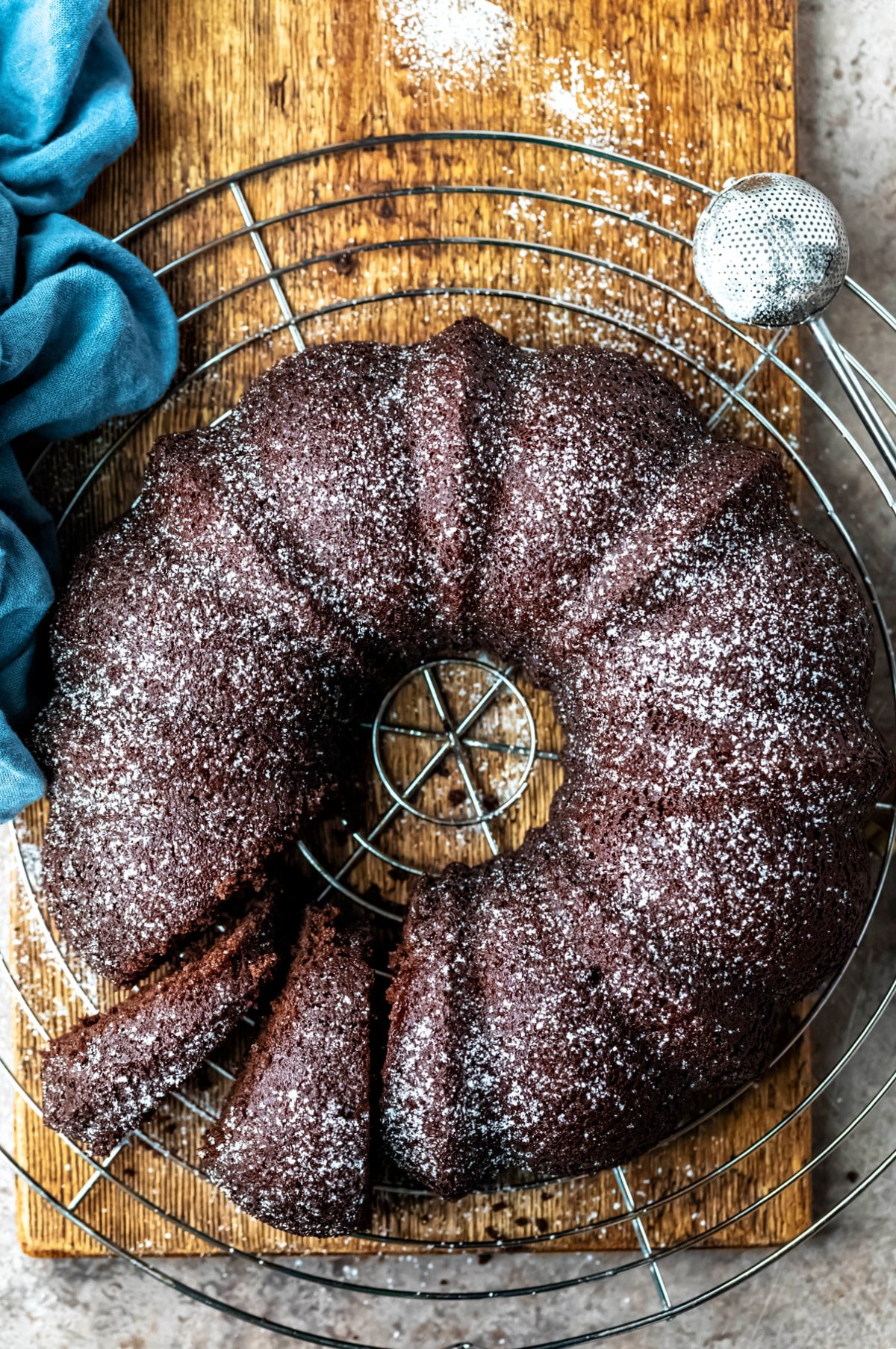 Chocolate Buttermilk Bundt Cake next to a powdered sugar sifter