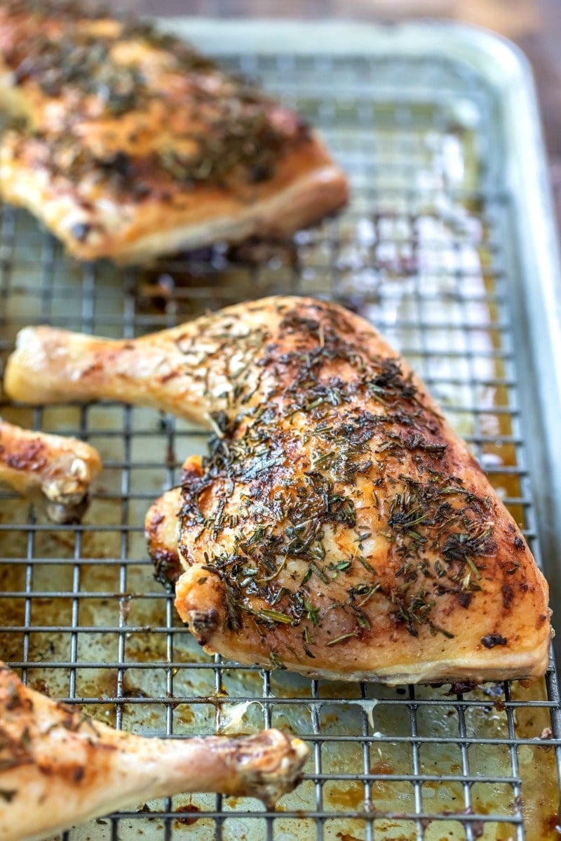 Piece of herb roasted chicken on a wire cooling rack