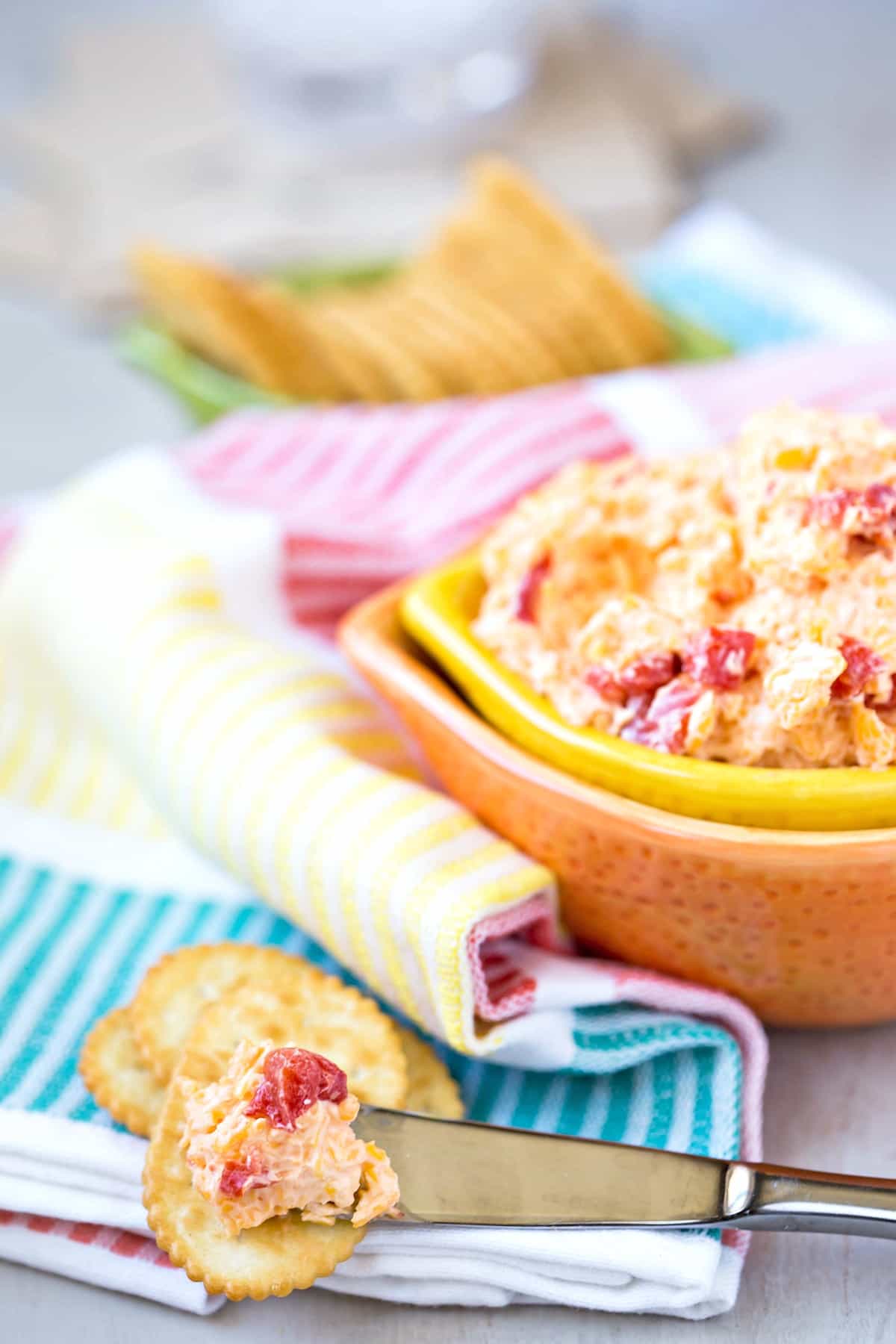 Pimento Cheese Dip on a knife spreading it onto a cracker