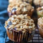 Healthy blueberry muffins on a dark wire cooling rack