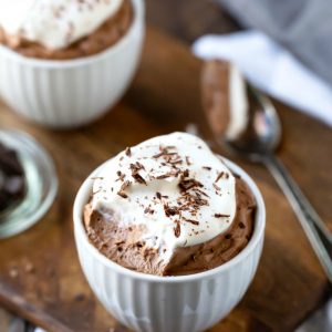 Chocolate mousse in a white dish with a bite missing