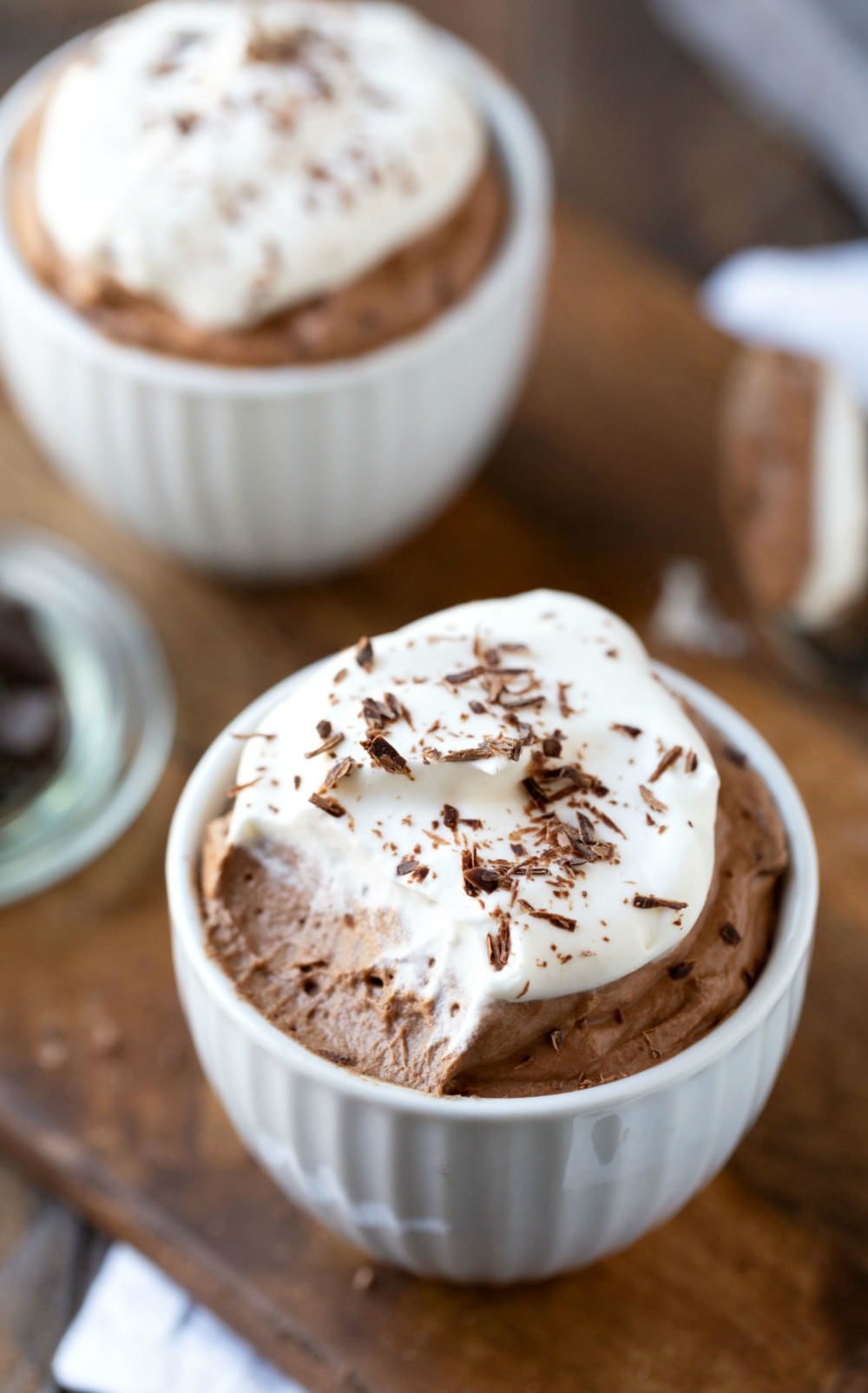 Chocolate mousse topped with whipped cream and chocolate shavings