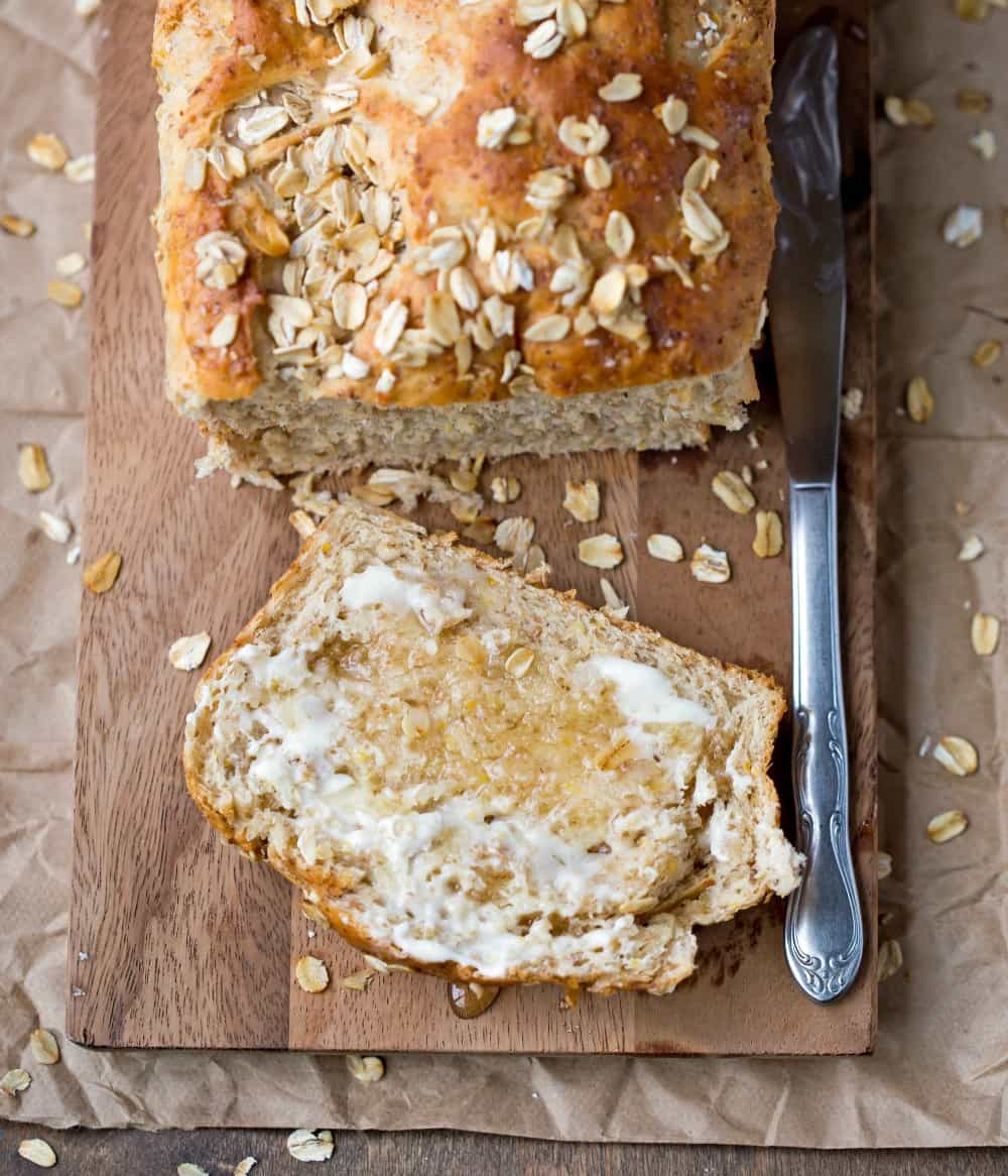 Slice of multigrain bread next to the loaf 