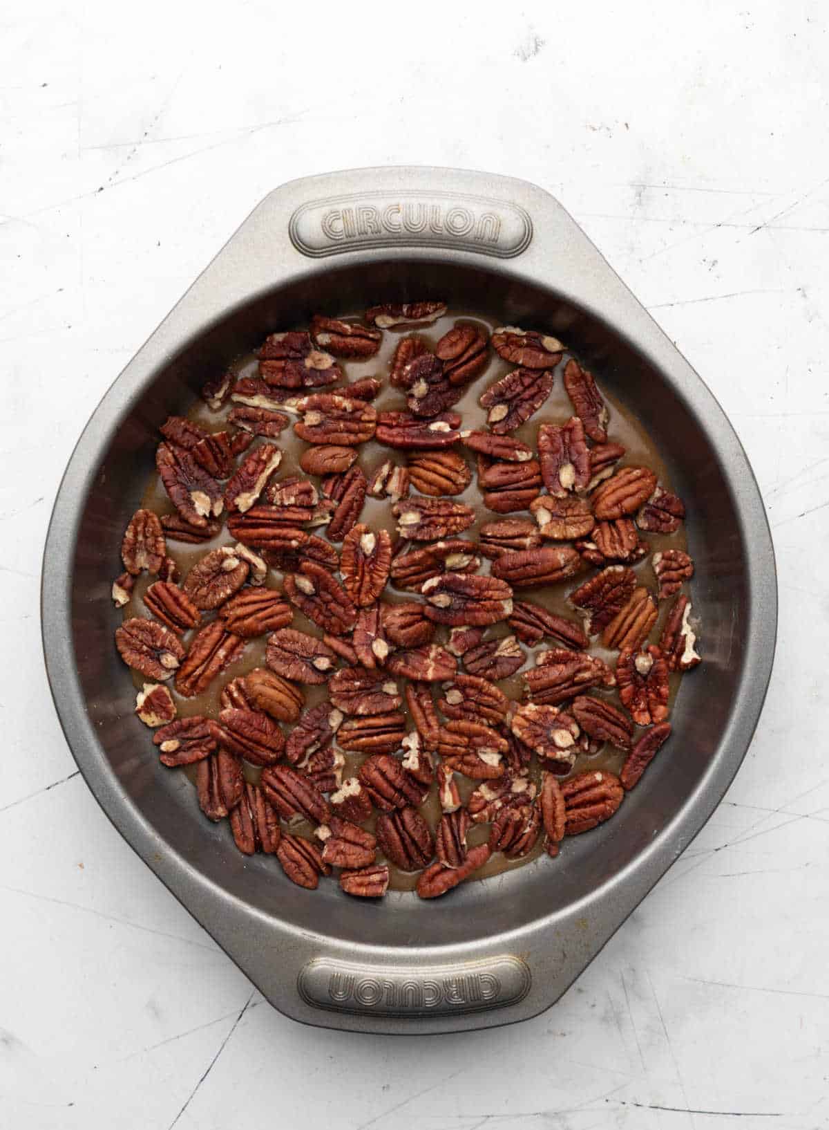 Pecans over topping in a cake pan.
