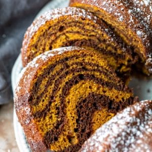 Slices of pumpkin marble cake on a white platter