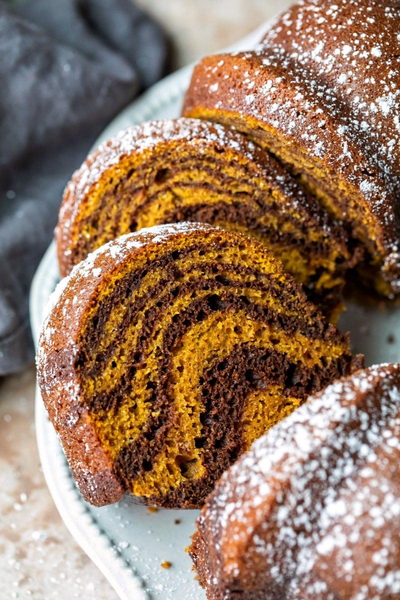 Slices of pumpkin marble cake on a white platter