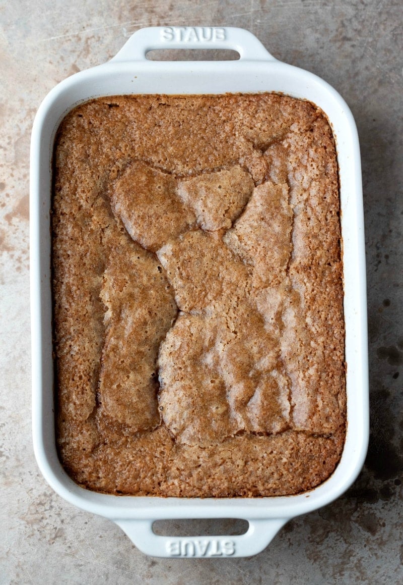 Caramel apple cobbler cake in a white baking pan.