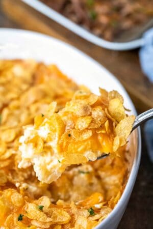 Silver spoon holding a scoop of funeral potatoes