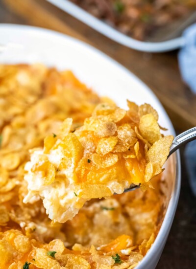 Silver spoon holding a scoop of funeral potatoes