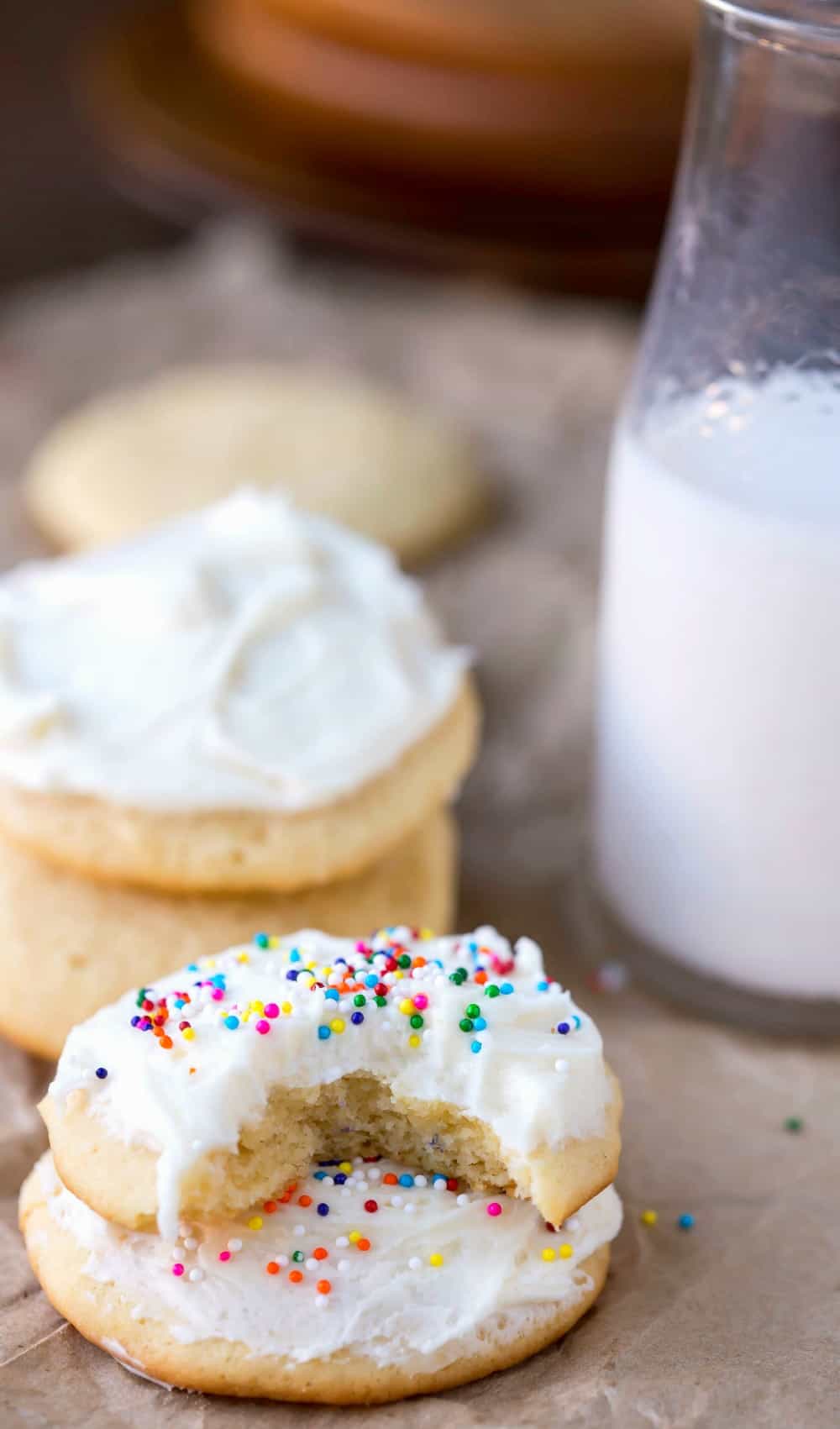 Sour Cream Sugar Cookie with a bite missing stacked on top of another cookie