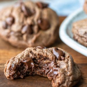 Nutella cookie with a bite out of it on a wooden cutting board
