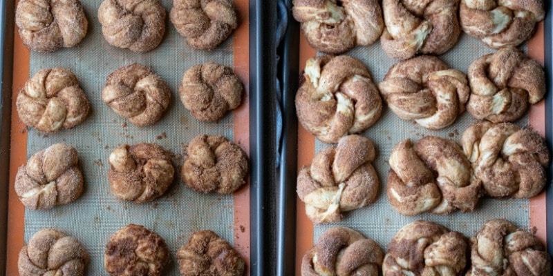 Unbaked cinnamon sugar knots on a baking sheet