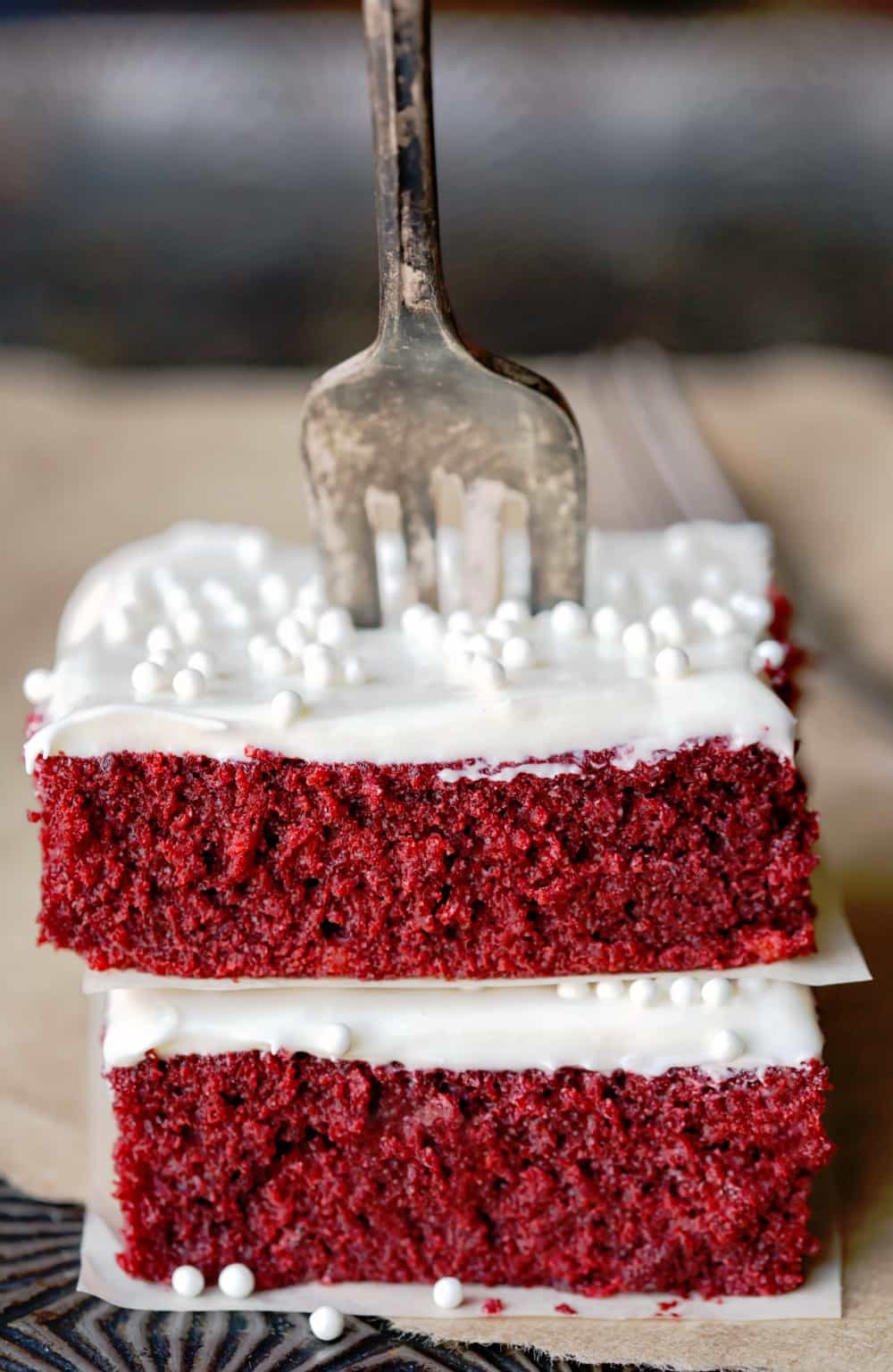 Two pieces of Red Velvet Sheet Cake stack on top of itself