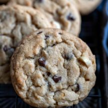 Peanut butter chocolate chip cookies on a black wire cooling rack