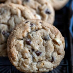 Peanut butter chocolate chip cookies on a black wire cooling rack