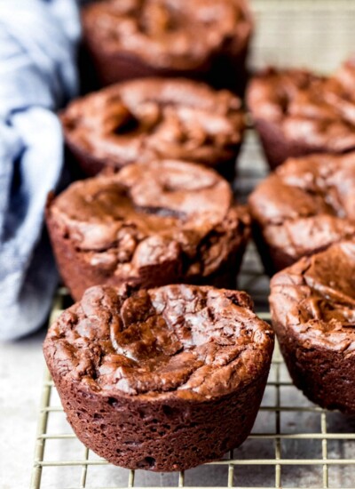 Muffin tin brownies on a wire cooling rack.