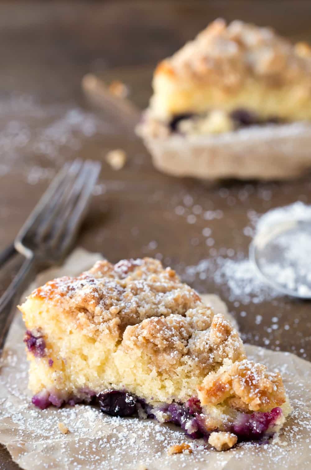 Slice of Blueberry Coffee Cake dusted with powdered sugar