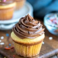 Chocolate cream cheese frosting on a yellow cupcake