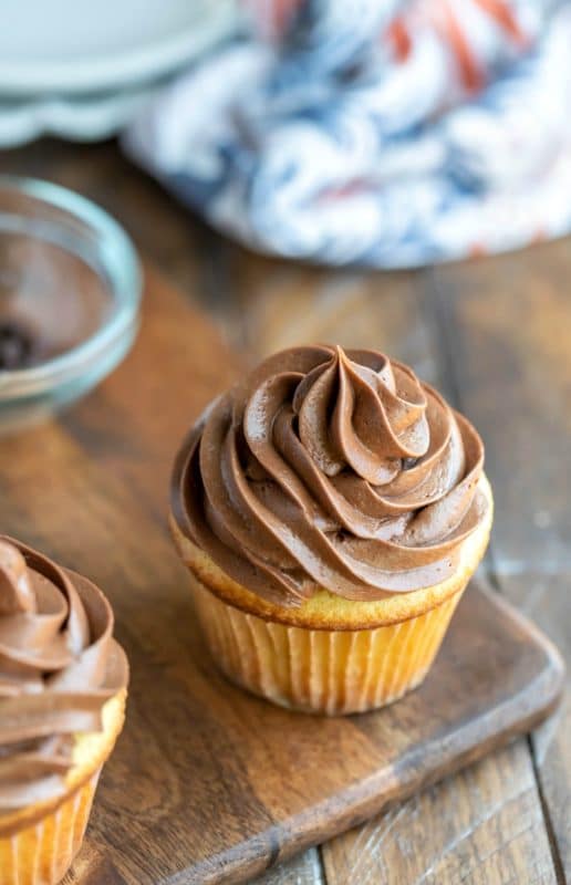 Chocolate Cream cheese frosting on a cupcake on a cutting board