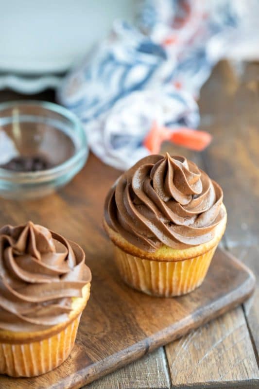 Chocolate cream cheese frosting on a white cupcake