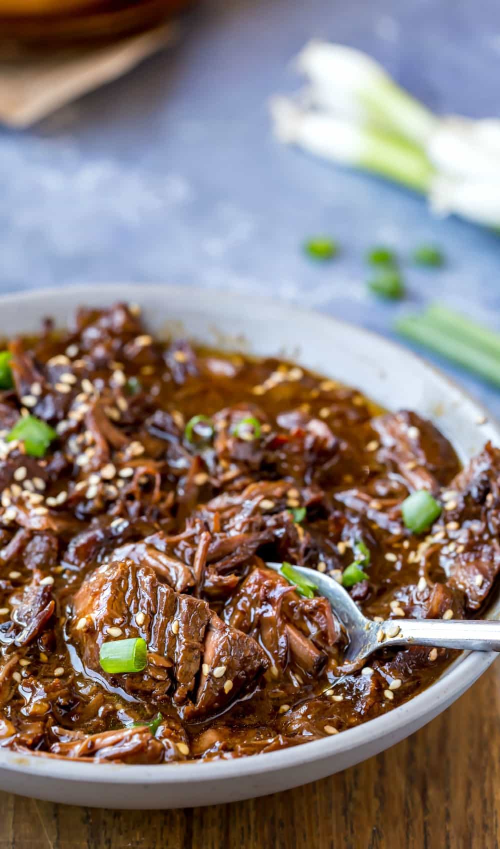 Slow Cooker Korean Beef Scooping Slow Cooker Korean Beef with a silver spoon