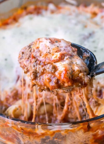 A black spoon scooping up ravioli Lasagna.