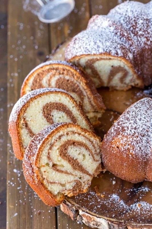 pieces of cinnamon swirl bundt cake on a wooden plate