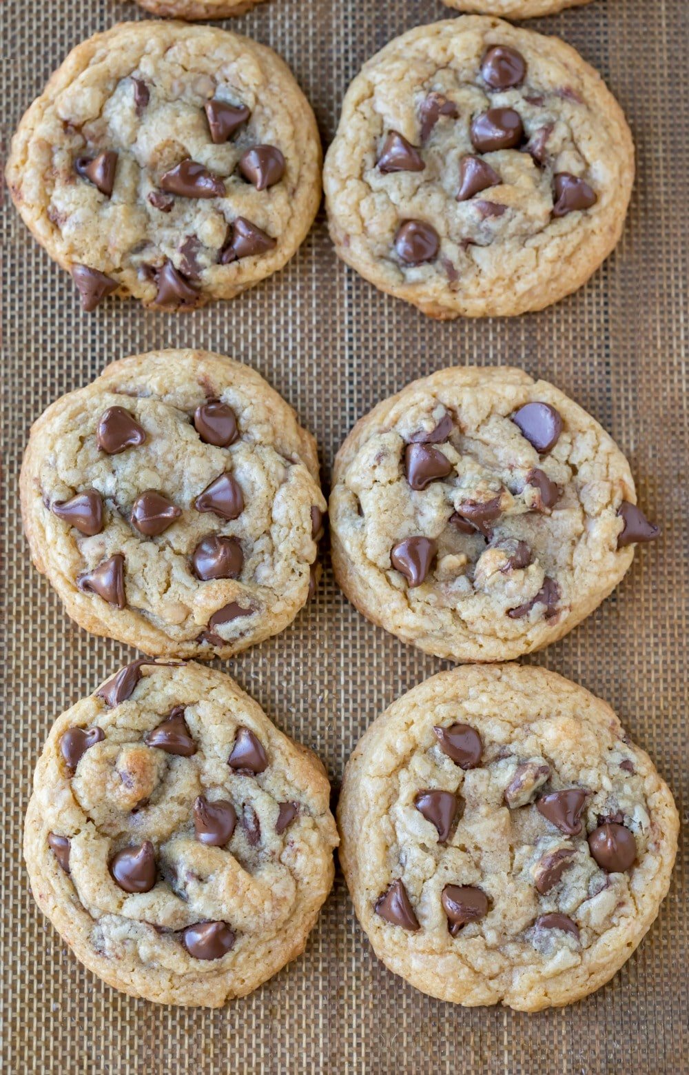 Toffee Chocolate Chip Cookies on a silicone baking mat. 