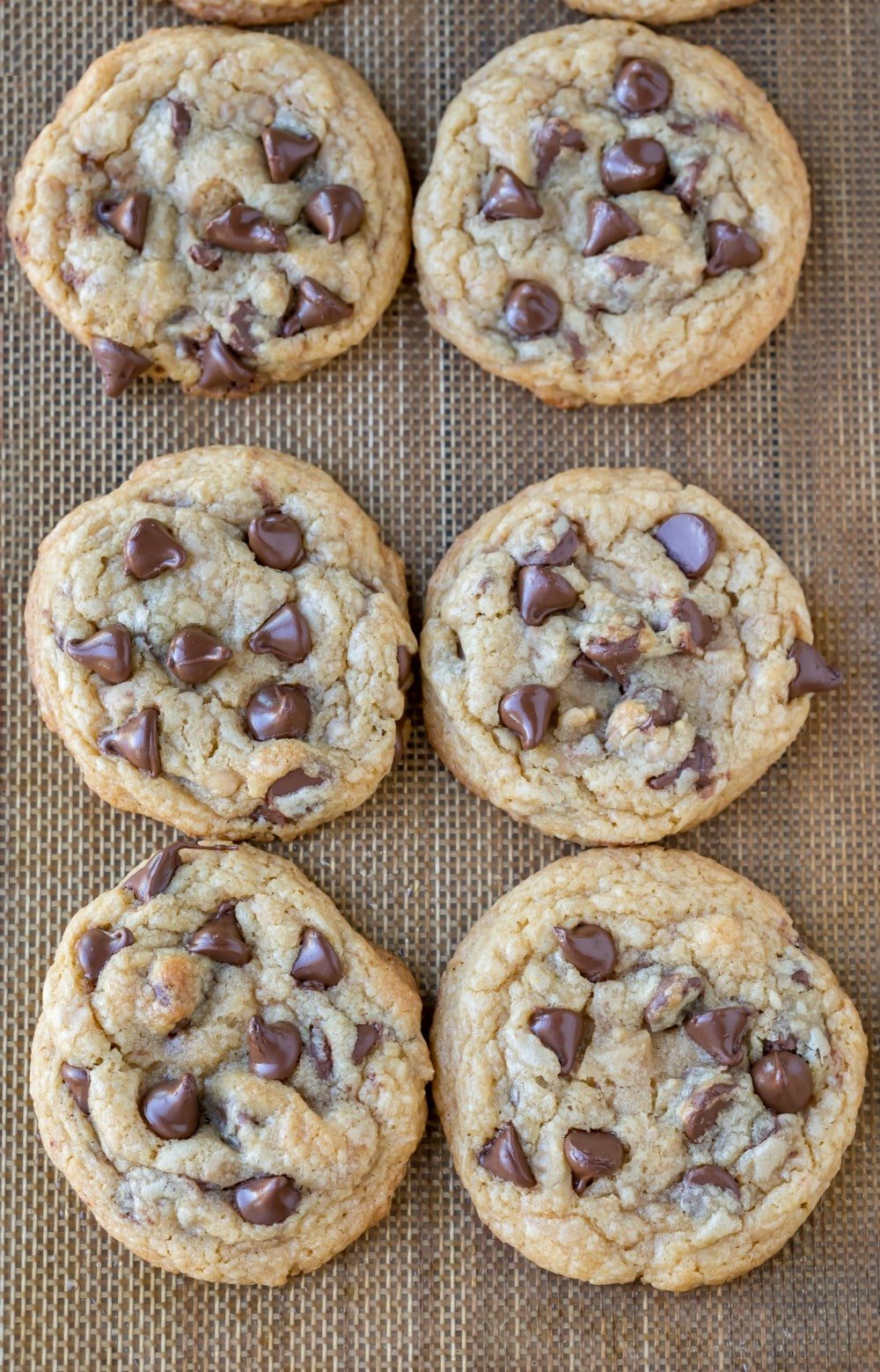 Toffee Chocolate Chip Cookies on a silicone baking mat.