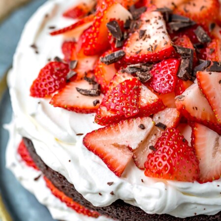 Strawberries and cream chocolate cake topped with chopped chocolate.