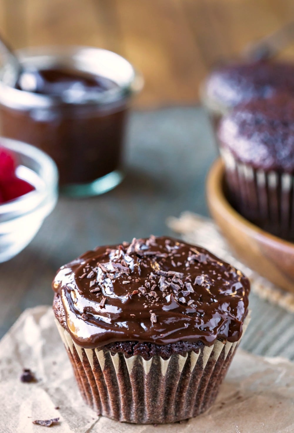 Chocolate Boston Cream Pie Cupcakes near bowl of raspberries