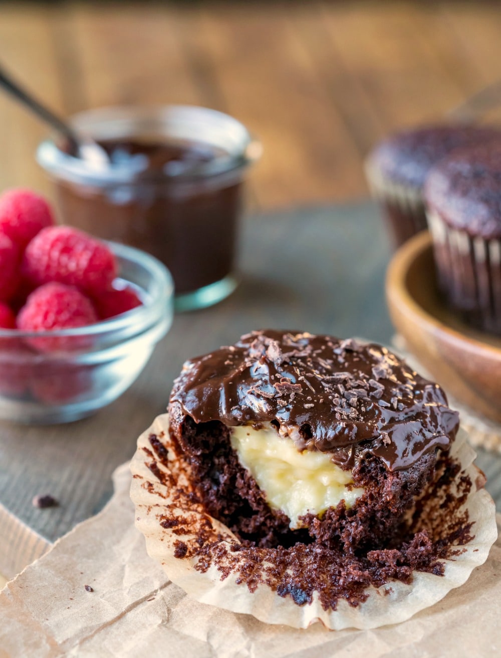 Chocolate Boston Cream Pie Cupcake with a bite missing