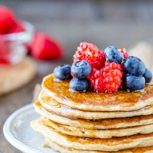 Stack of cottage cheese pancakes with berries on top