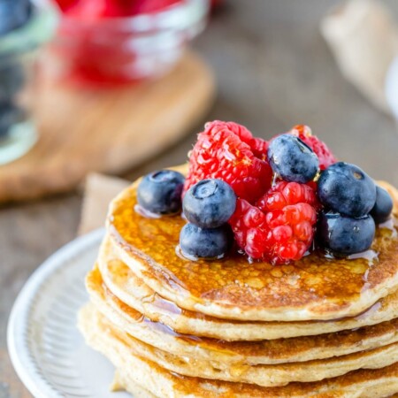 Berries and syrup on stack of cottage cheese pancakes