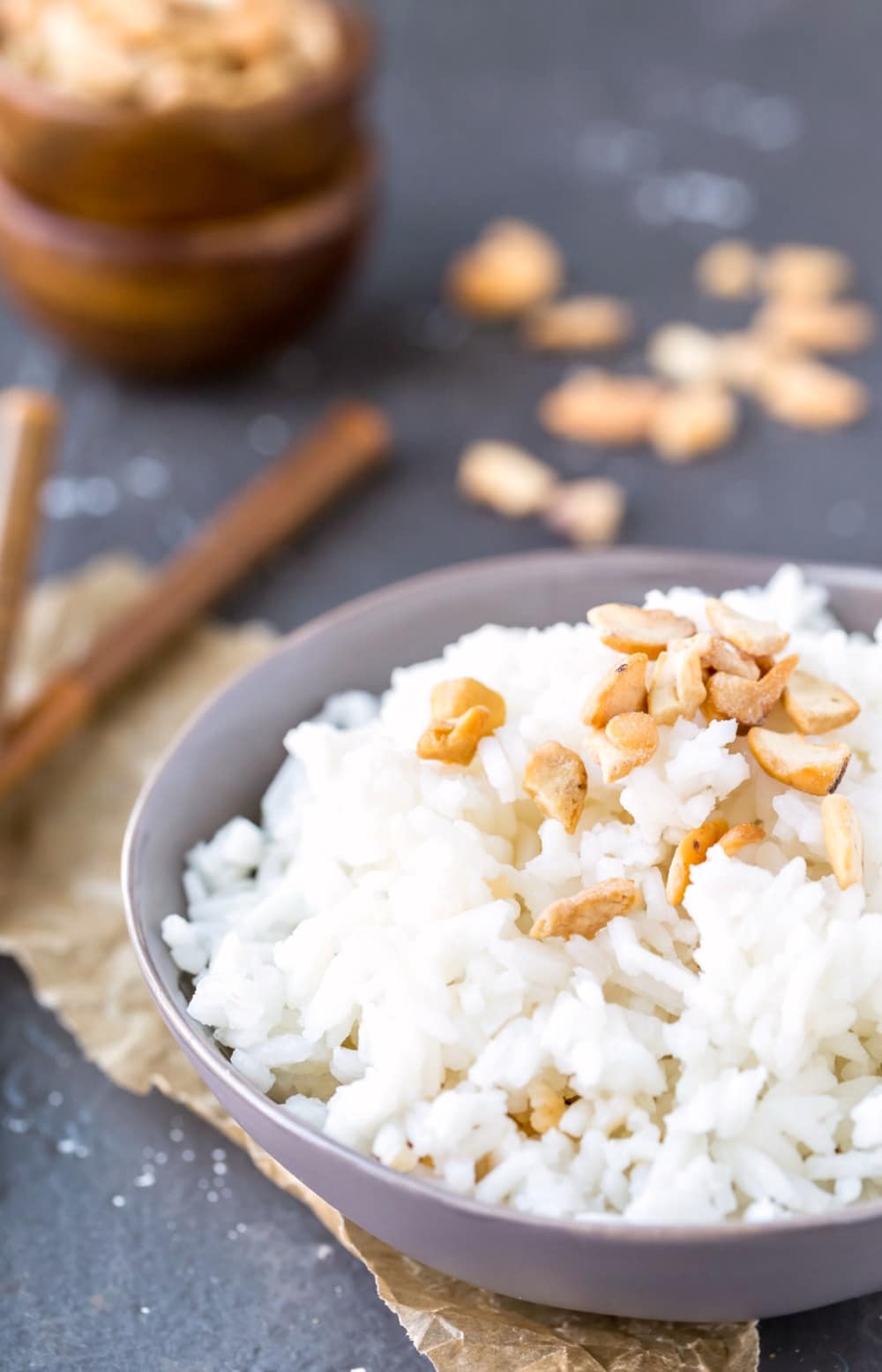 Coconut rice in a blue bowl topped with pieces of cashew