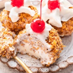 Three scoops of no fry fried ice cream one with a spoonful missing.