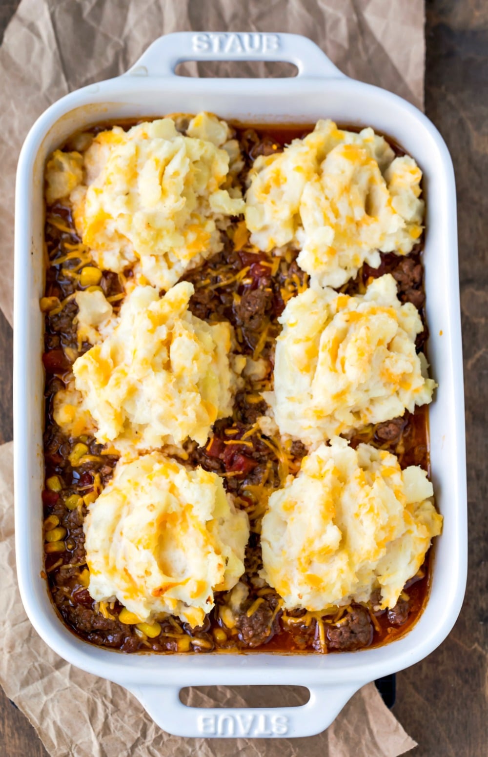 Barbecue shepherd's pie in a white baking dish on a piece of brown parchment paper