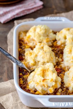 White baking dish with barbecue shepherd's pie inside of it