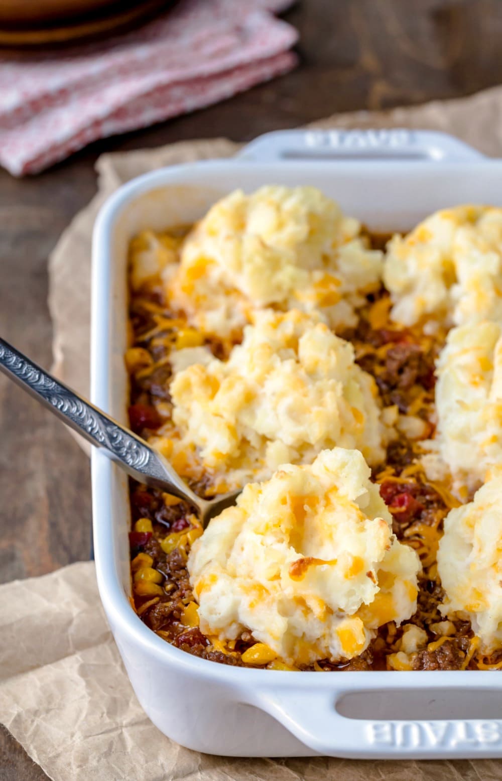 White baking dish with barbecue shepherd's pie inside of it