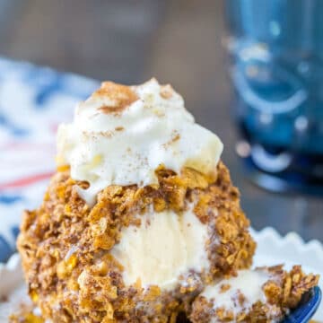 No-Fry Fried Ice Cream on a white dish next to a blue spoon and blue cup