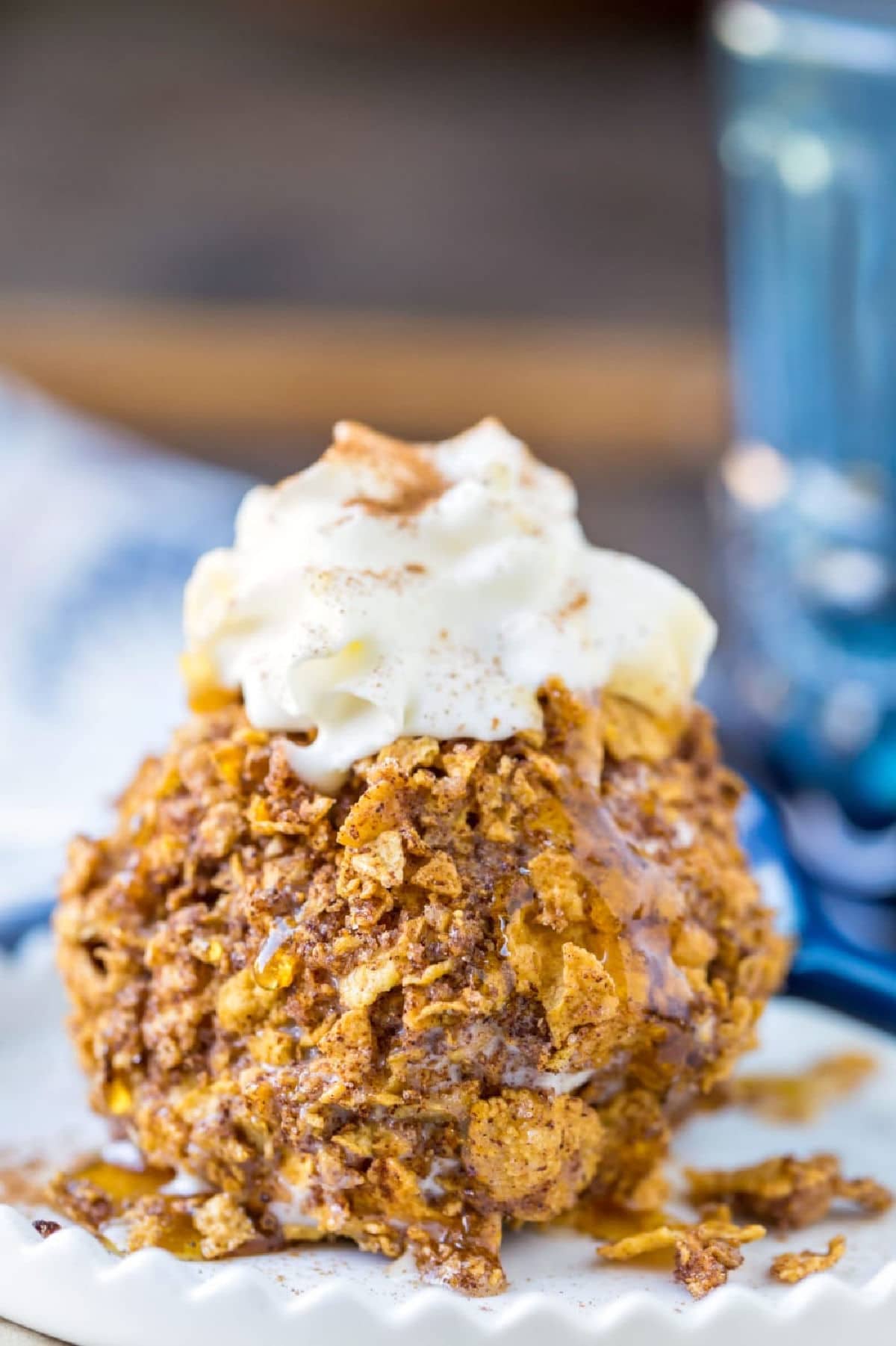No-Fry Fried Ice Cream Scoop of no-fry fried ice cream topped with whipped cream.