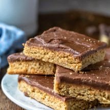 Four peanut butter bars on a white plate
