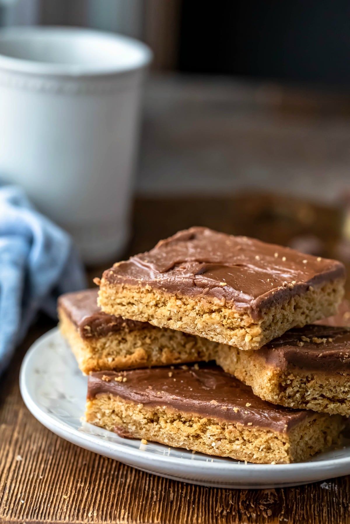 Plate of peanut butter bars next to a blue linen napkin