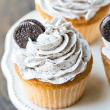 White cupcake with OREO frosting and a mini oreo on top