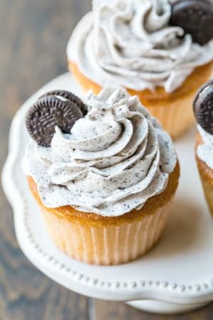 White cupcake with OREO frosting and a mini oreo on top