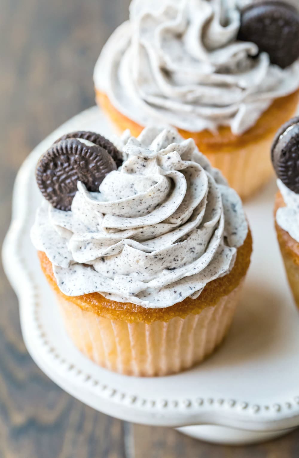 White cupcake with OREO frosting and a mini oreo on top