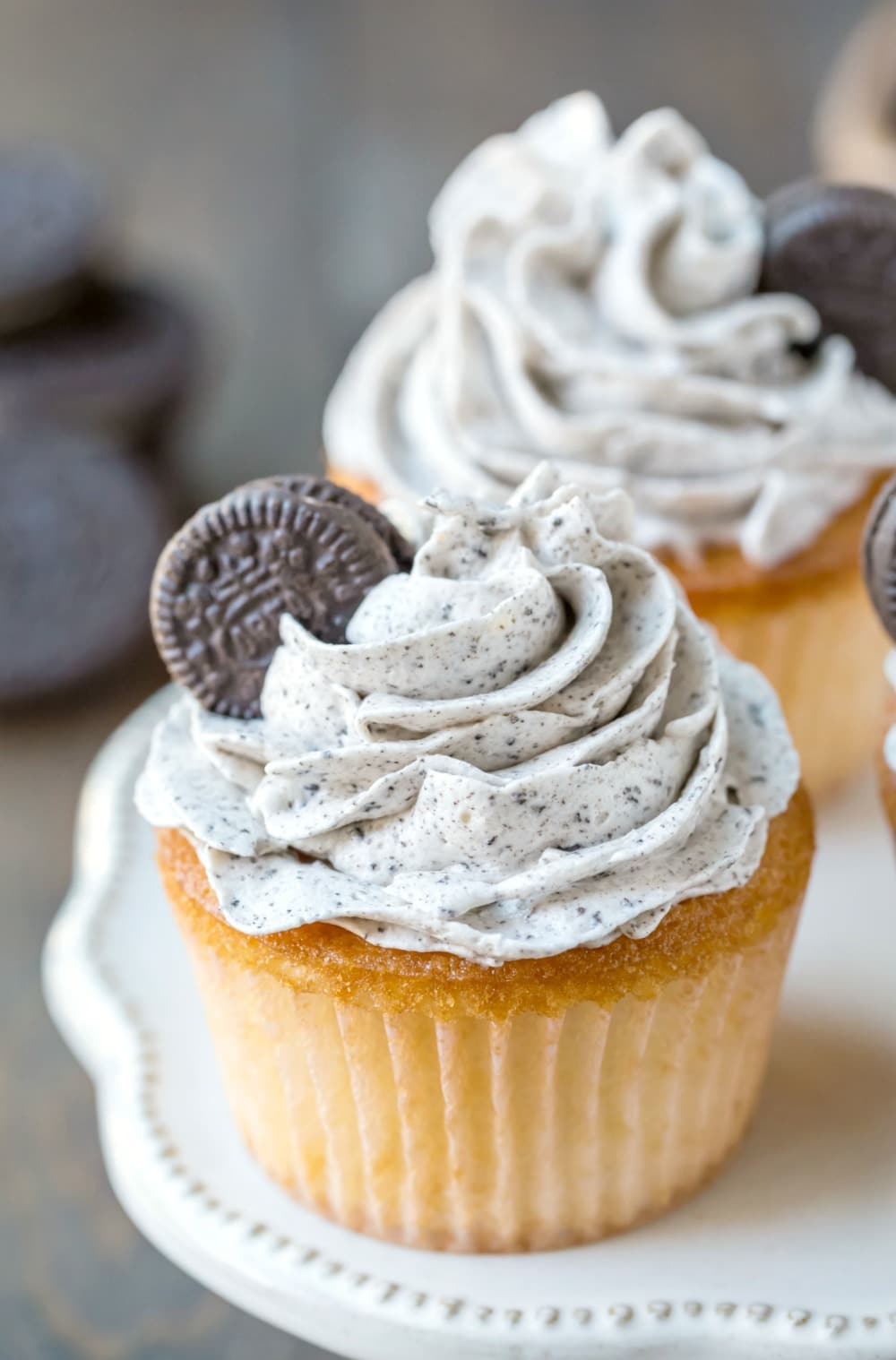 White cupcake frosted with OREO frosting and topped with a mini OREO