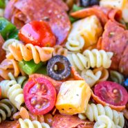Pasta salad with pepperoni, olives, cheese, and tomatoes