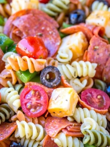Pasta salad with pepperoni, olives, cheese, and tomatoes